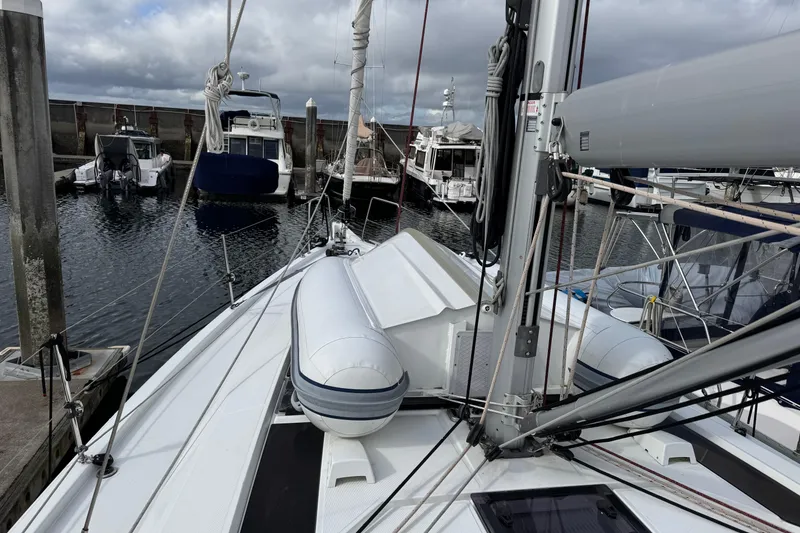 Slide: The Image of 2022 Beneteau Oceanis 46.1 sailboat docked in a marina, featuring a sleek deck design. - 56