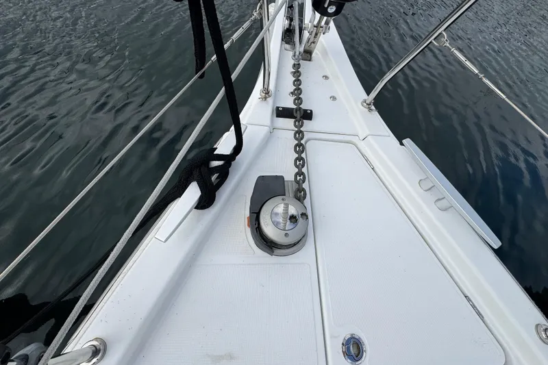 Slide: The Image of Bow of 2022 Beneteau Oceanis 46.1 sailboat with anchor chain and winch. - 59
