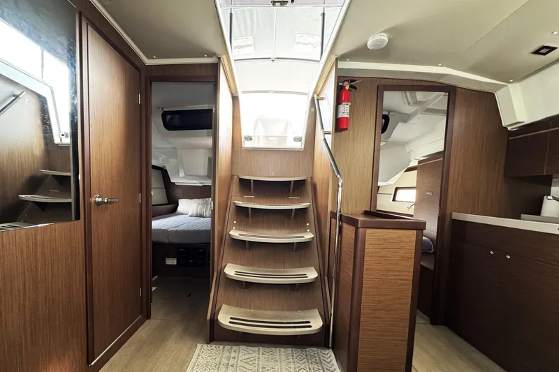 Slide: The Image of Interior of 2022 Beneteau Oceanis 46.1 yacht, featuring wooden finishes and modern design. - 7