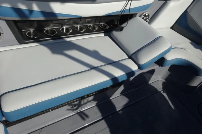 Slide: The Image of 2022 Axis T23 boat interior with cushioned seating and cup holders. - 11