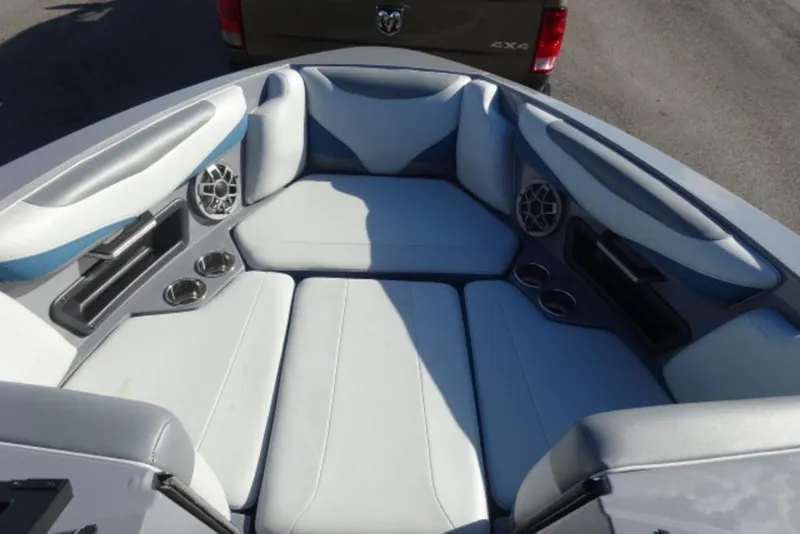 Slide: The Image of 2022 Axis T23 boat interior with cushioned seating and built-in speakers. - 15