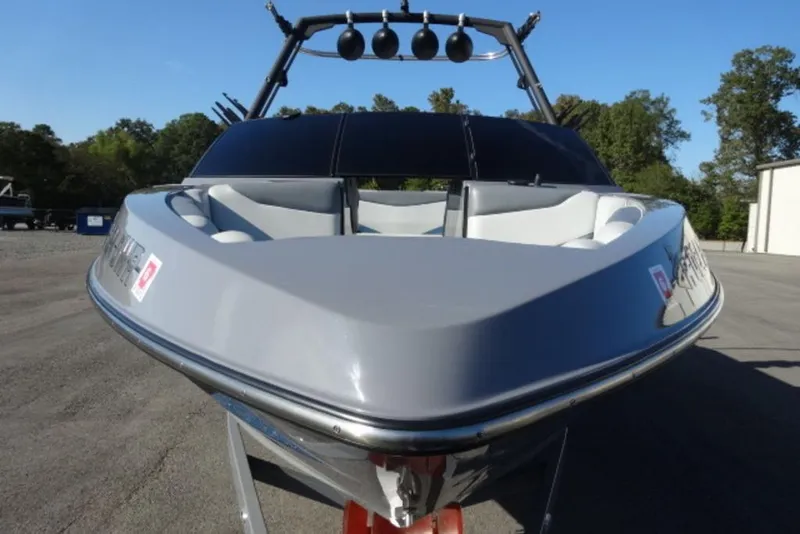 Slide: The Image of 2022 Axis T23 boat with sleek design, parked outdoors on a sunny day. - 5