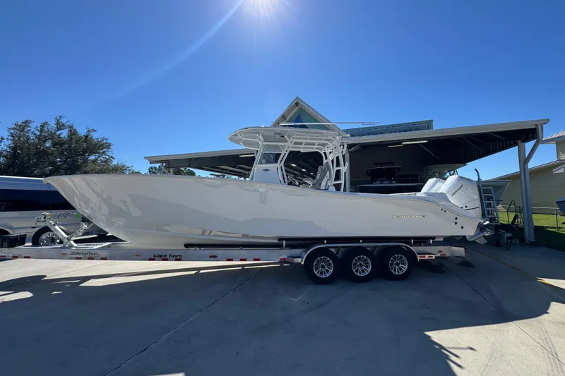 The Image of 2026 Cape Horn 34 XS boat on trailer under clear blue sky. - 1