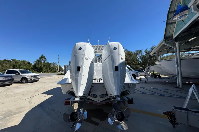 Slide: The Image of 2026 Cape Horn 34 XS boat with dual outboard engines in a marina setting. - 11