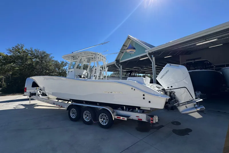 Slide: The Image of 2026 Cape Horn 34 XS boat on trailer under sunny sky. - 14