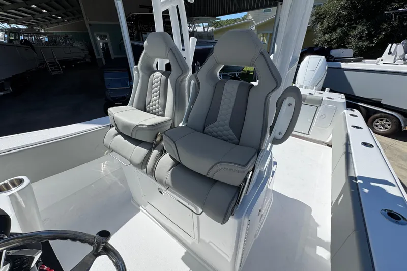 Slide: The Image of 2026 Cape Horn 34 XS boat with luxurious gray seating in a showroom. - 23