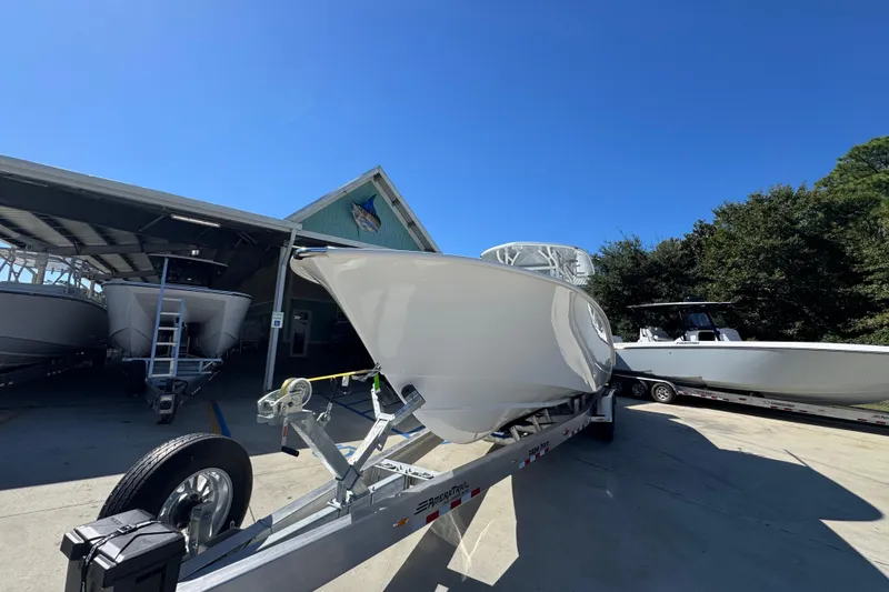 Slide: The Image of 2026 Cape Horn 34 XS boat on trailer under clear blue sky. - 4