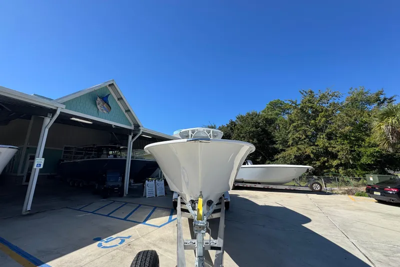 Slide: The Image of 2026 Cape Horn 34 XS boat on trailer at marina under clear blue sky. - 5