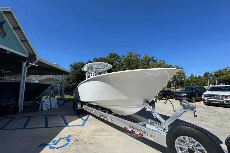 Slide: The Image of 2026 Cape Horn 34 XS boat on trailer under clear blue sky. - 6