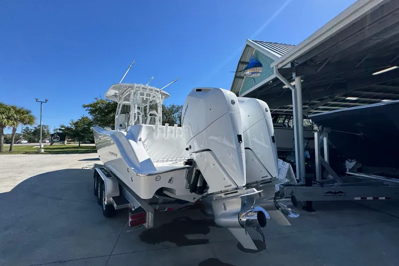 Slide: The Image of 2026 Cape Horn 34 XS boat with dual engines on a trailer under clear blue sky. - 12