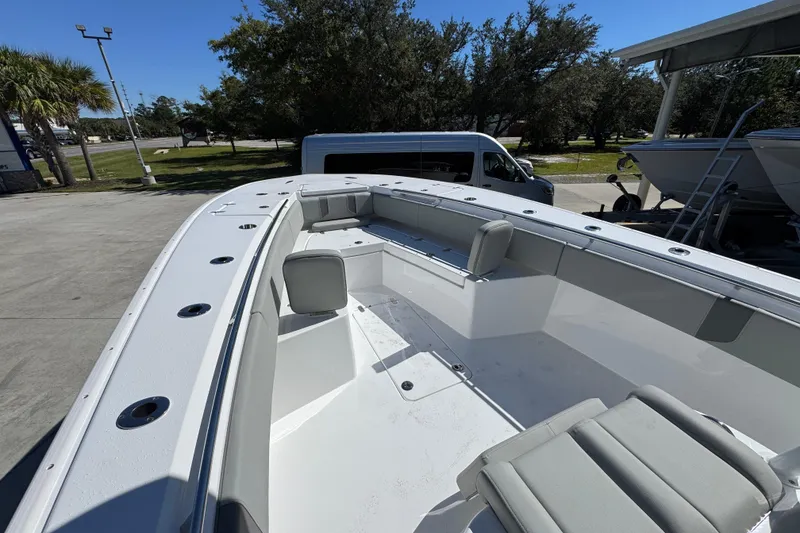 Slide: The Image of 2026 Cape Horn 34 XS boat interior with seating, docked outdoors on a sunny day. - 17