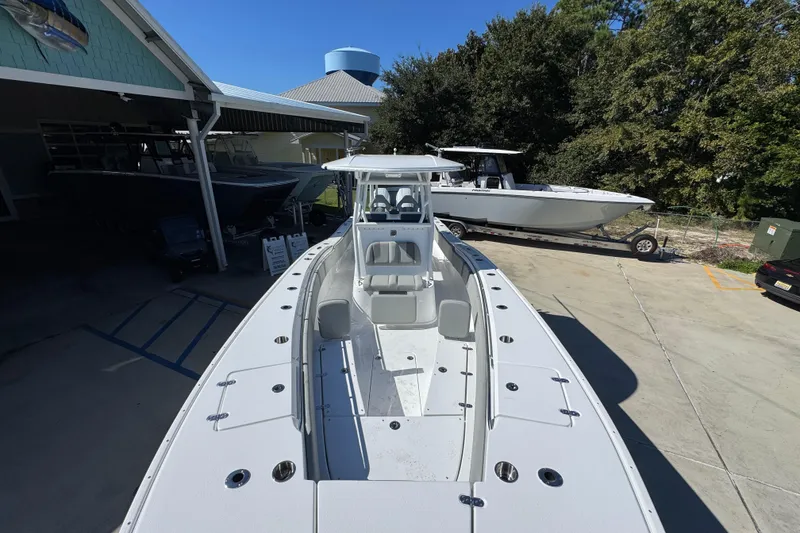 Slide: The Image of 2026 Cape Horn 34 XS boat in a marina, showcasing sleek design and spacious deck. - 19