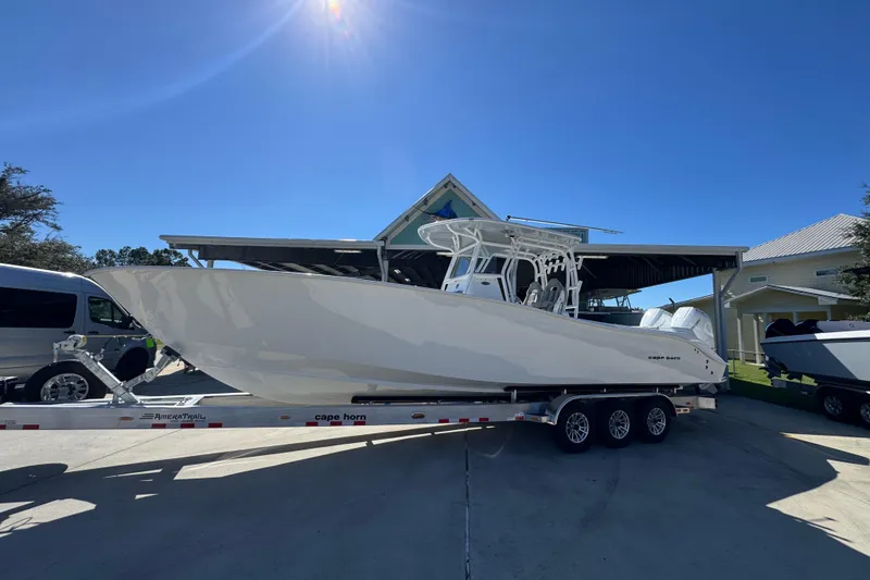 Slide: The Image of 2026 Cape Horn 34 XS boat on trailer under clear blue sky. - 2
