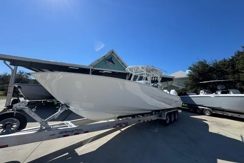 Slide: The Image of 2026 Cape Horn 34 XS boat on trailer under clear blue sky. - 3