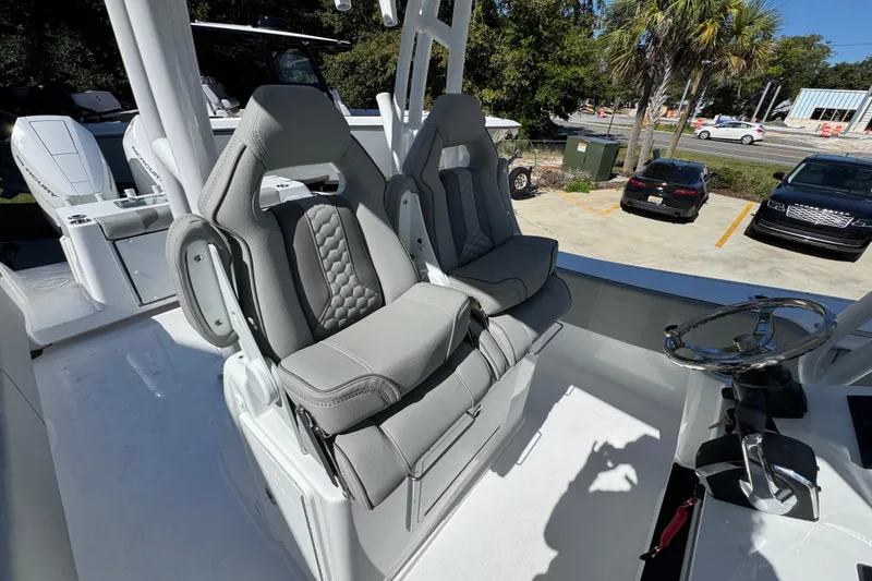 Slide: The Image of 2026 Cape Horn 34 XS boat interior with luxury seating and steering wheel. - 30
