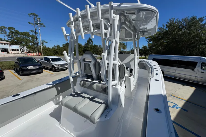 Slide: The Image of 2026 Cape Horn 34 XS boat with seating and rod holders, parked in a lot. - 33