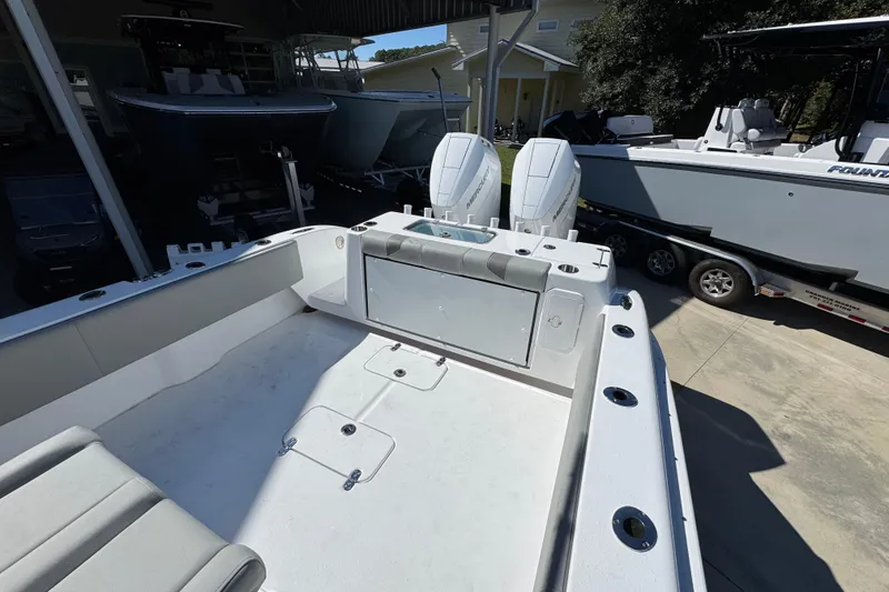 Slide: The Image of 2026 Cape Horn 34 XS boat interior with dual engines, docked in a marina. - 34