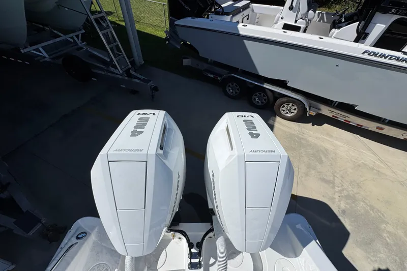 Slide: The Image of 2026 Cape Horn 34 XS with dual Mercury outboard engines, parked near a trailer. - 39