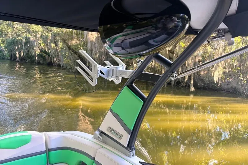 Slide: The Image of 2017 Chaparral Vortex 243 VRX boat interior with green accents and wakeboard rack. - 10