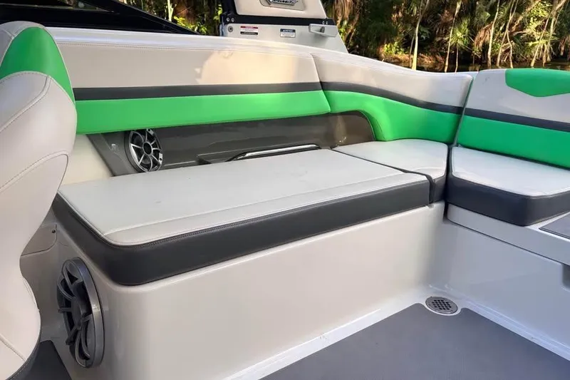 Slide: The Image of 2017 Chaparral Vortex 243 VRX boat interior with green and white seating. - 12