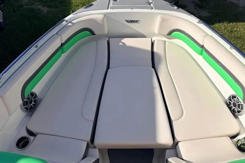 Slide: The Image of 2017 Chaparral Vortex 243 VRX boat interior with beige seating and green accents. - 5