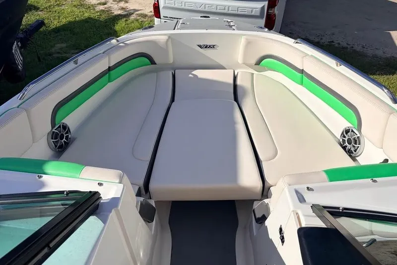 Slide: The Image of 2017 Chaparral Vortex 243 VRX boat interior with green accents and seating area. - 6