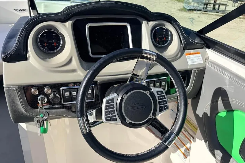 Slide: The Image of 2017 Chaparral Vortex 243 VRX boat dashboard with steering wheel and controls. - 8