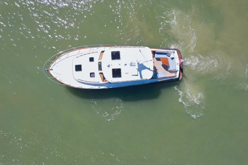 Slide: The Image of Overhead view of 2015 Hinckley Talaria 43 yacht cruising on water. - 1