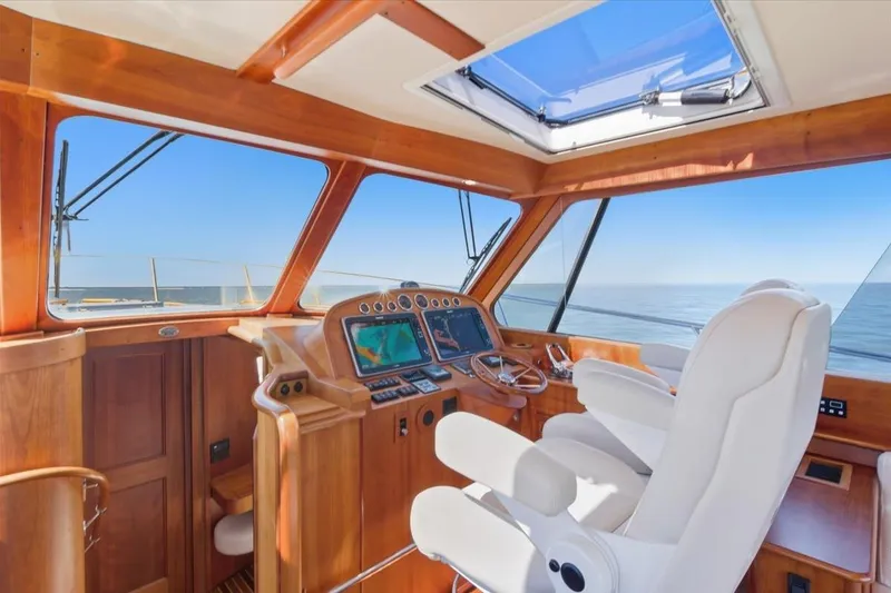 Slide: The Image of Helm of 2015 Hinckley Talaria 43 yacht with wooden interior and ocean view. - 13