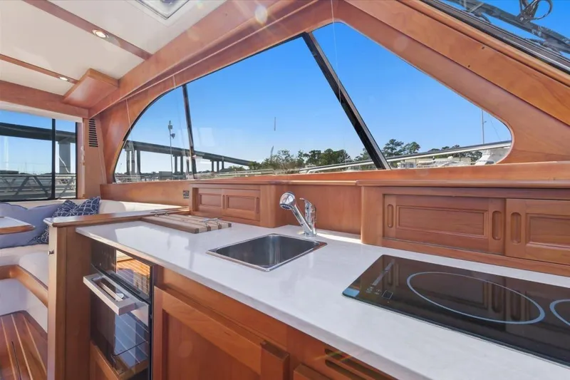 Slide: The Image of Interior of 2015 Hinckley Talaria 43 yacht with modern kitchen and panoramic windows. - 10