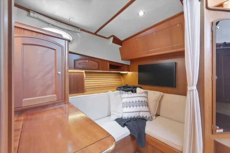 Slide: The Image of Luxurious interior of 2015 Hinckley Talaria 43 yacht with cozy seating and elegant wood finish. - 14