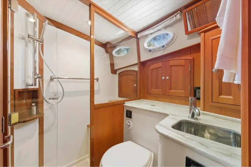 Slide: The Image of Luxurious 2015 Hinckley Talaria 43 yacht bathroom with wood accents and modern fixtures. - 15