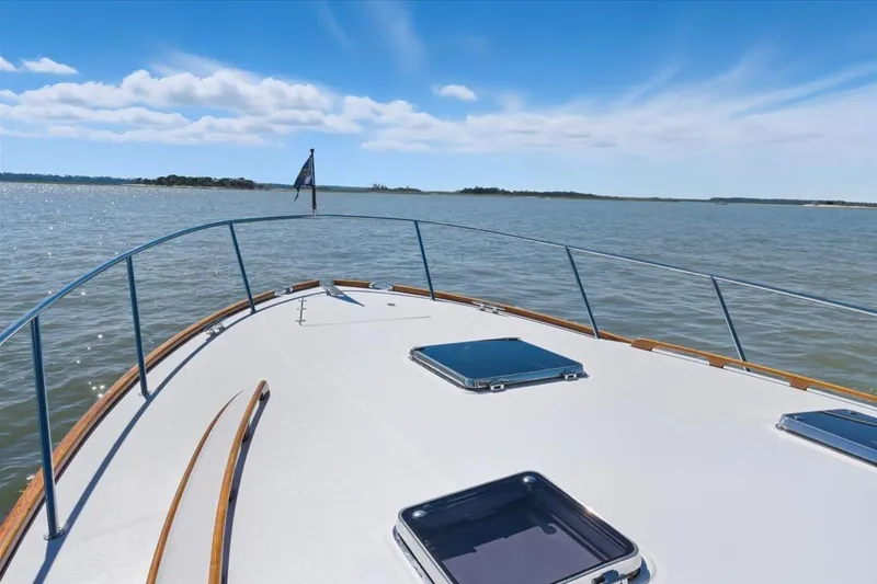 Slide: The Image of Bow view of 2015 Hinckley Talaria 43 yacht on open water under blue sky. - 17
