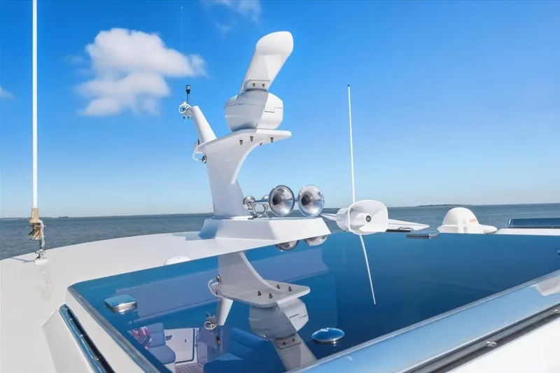 Slide: The Image of 2015 Hinckley Talaria 43 yacht with radar equipment against a clear blue sky. - 23