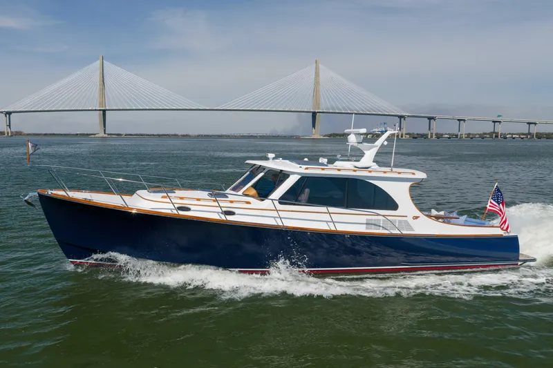 Slide: The Image of 2015 Hinckley Talaria 43 yacht cruising near a bridge on a sunny day. - 24
