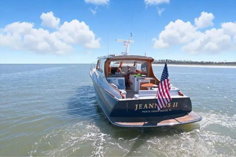 Slide: The Image of 2015 Hinckley Talaria 43 yacht on open water, American flag displayed. - 4