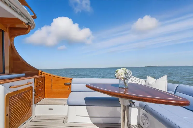 Slide: The Image of Luxurious 2015 Hinckley Talaria 43 yacht interior with ocean view and elegant seating area. - 7