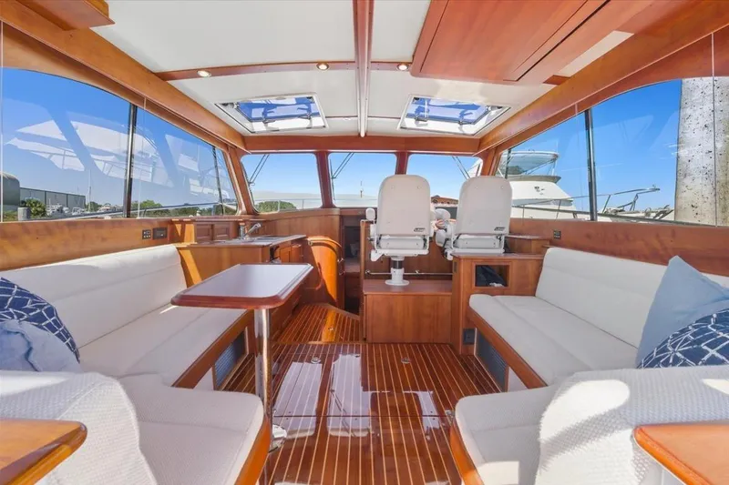 Slide: The Image of Luxurious interior of 2015 Hinckley Talaria 43 yacht with elegant wood finish and plush seating. - 9