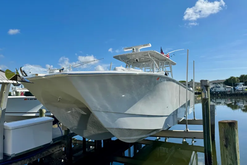 The Image of 2021 SeaHunter 41 CTS boat on calm water, with scenic marina background. - 0