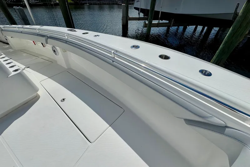 Slide: The Image of 2021 SeaHunter 41 CTS boat with luxurious seating and rod holders, docked by the water. - 13