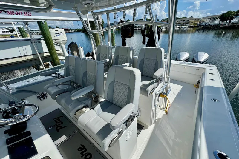 Slide: The Image of 2021 SeaHunter 41 CTS boat cruising on a calm waterway with scenic background. - 4