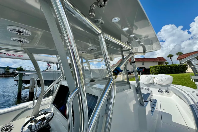 Slide: The Image of 2021 SeaHunter 41 CTS boat cruising on calm waters near a coastal town. - 7