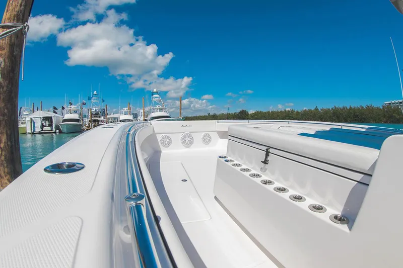 Slide: The Image of 2021 SeaHunter 41 CTS boat cruising on calm water near a marina. - 8