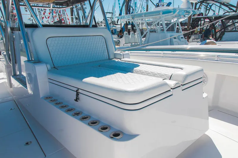 Slide: The Image of 2021 SeaHunter 41 CTS boat interior with cushioned seating and rod holders. - 9