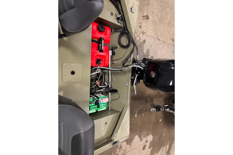Slide: The Image of 2024 Tracker Grizzly 1648 SC boat interior with engine and fuel system components. - 13