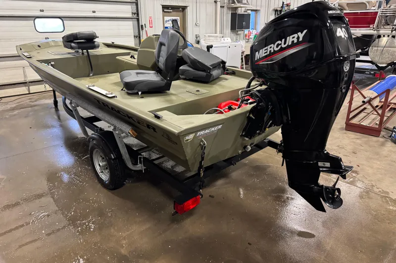 Slide: The Image of 2024 Tracker Grizzly 1648 SC boat with Mercury 40 HP engine in a garage. - 4