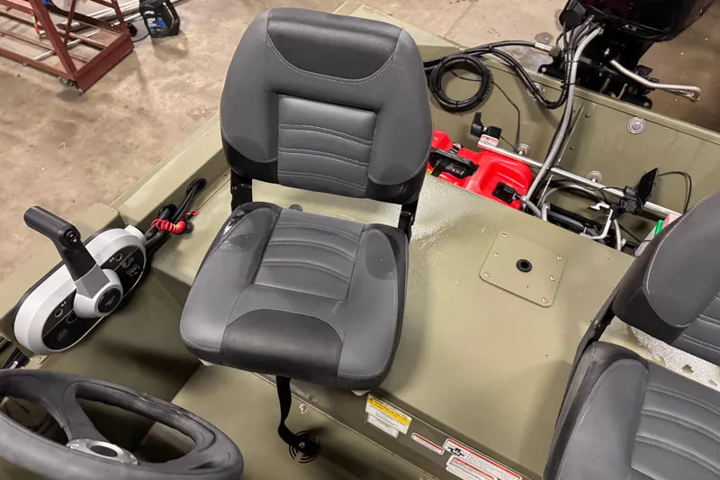 Slide: The Image of 2024 Tracker Grizzly 1648 SC boat interior with steering wheel and seat. - 6