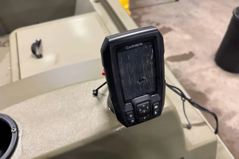 Slide: The Image of Garmin device on 2024 Tracker Grizzly 1648 SC boat dashboard, close-up view. - 9