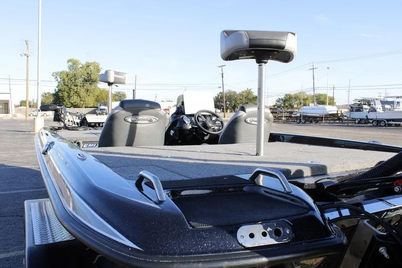 Slide: The Image of 2025 Phoenix 921 ELITE boat with spacious deck and seating in a parking lot. - 10