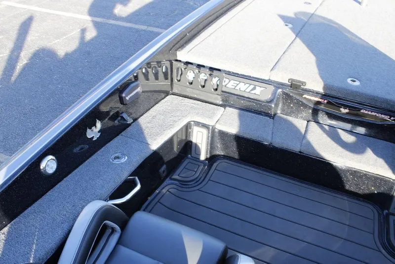 Slide: The Image of 2025 Phoenix 921 ELITE boat interior with control panel and seating area. - 13